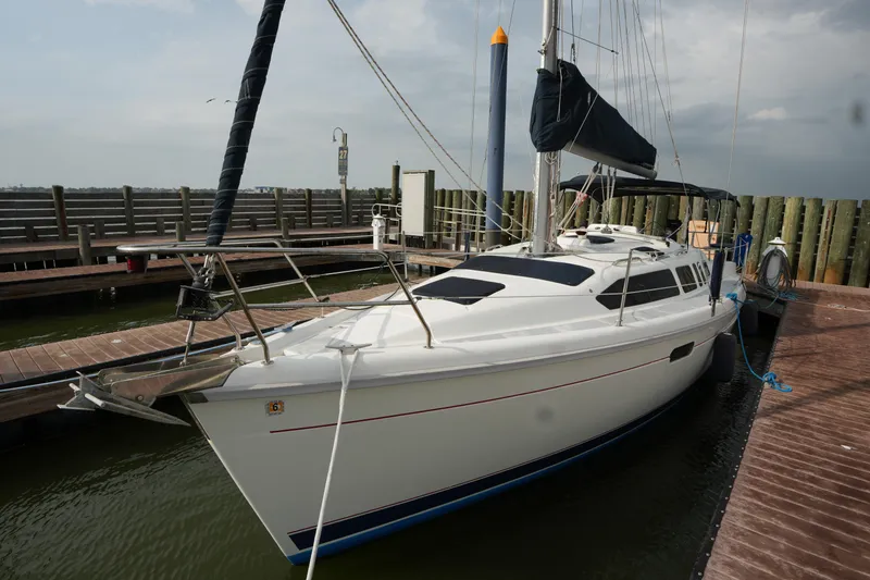 Slide: The Image of 1997 Hunter 336 sailboat docked at marina, featuring sleek white hull and modern design. - 4