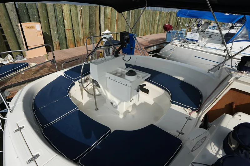 Slide: The Image of Cockpit of a 1997 Hunter 336 sailboat with blue cushioned seating. - 6