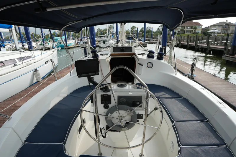 Slide: The Image of Cockpit view of a 1997 Hunter 336 sailboat docked at a marina. - 7