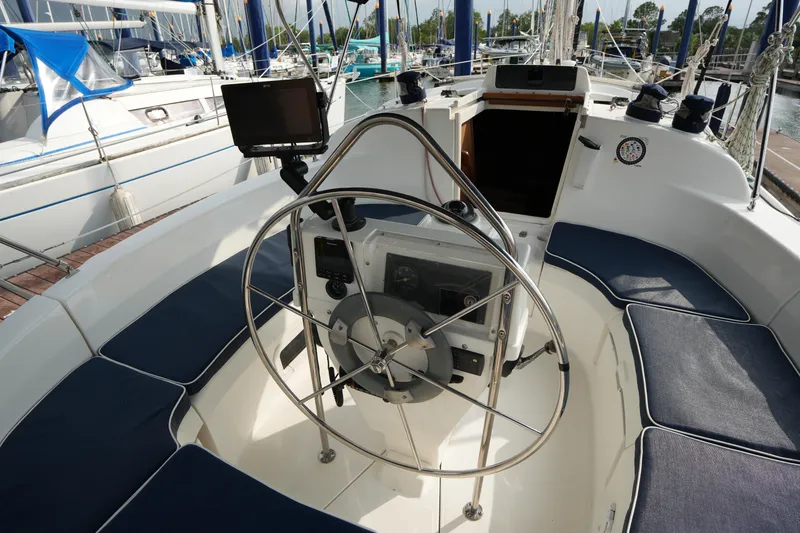 Slide: The Image of Cockpit of a 1997 Hunter 336 sailboat with steering wheel and navigation equipment. - 8