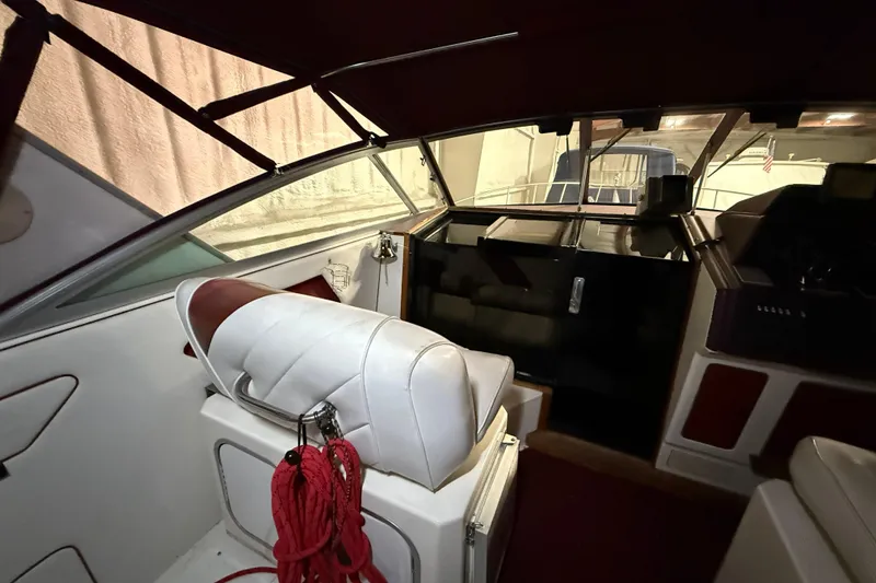 Slide: The Image of 1989 Sea Ray 340 Express Cruiser interior with white seating and red accents. - 14