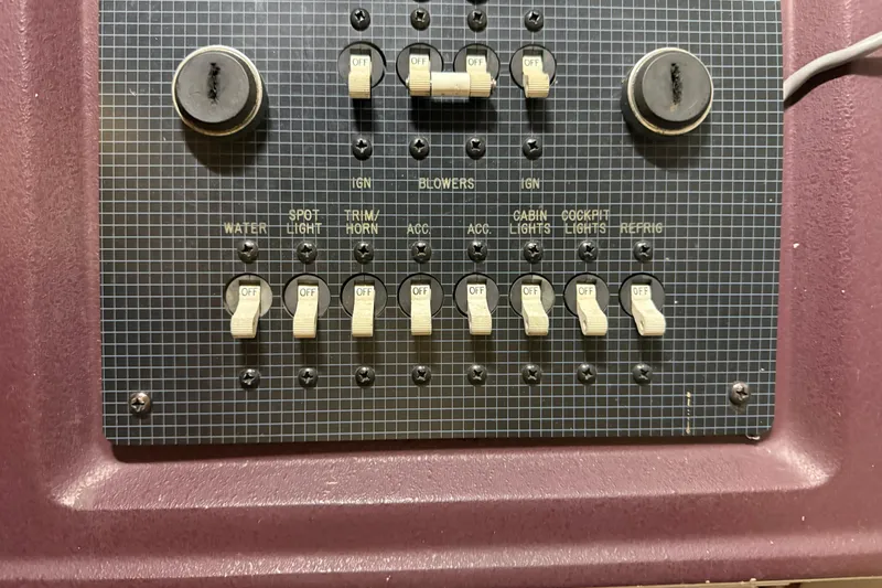 Slide: The Image of Control panel of a 1989 Sea Ray 340 Express Cruiser with labeled switches. - 17