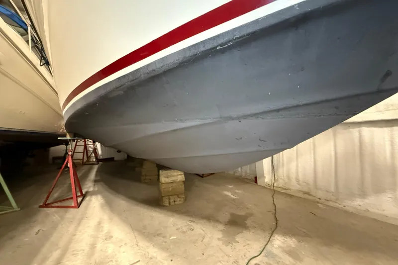 Slide: The Image of 1989 Sea Ray 340 Express Cruiser hull on supports in storage facility. - 2