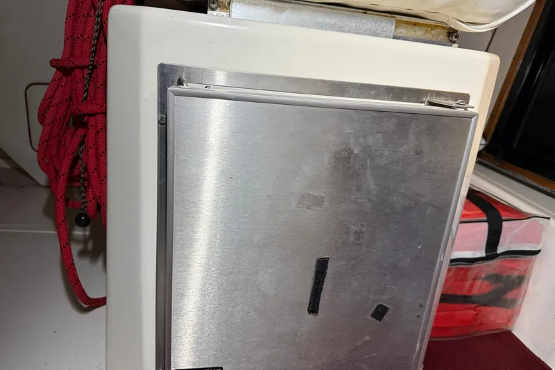 Slide: The Image of Stainless steel panel on 1989 Sea Ray 340 Express Cruiser with red rope and storage bag. - 21