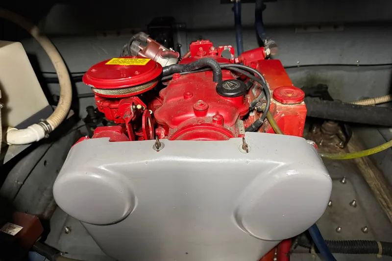 Slide: The Image of Engine compartment of a 1989 Sea Ray 340 Express Cruiser, featuring a red engine. - 23