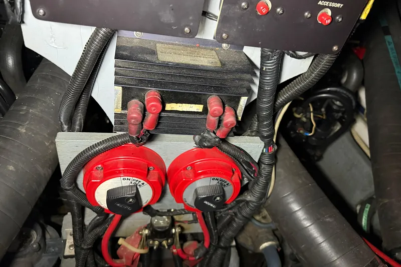 Slide: The Image of Engine compartment of a 1989 Sea Ray 340 Express Cruiser with electrical components and wiring. - 25