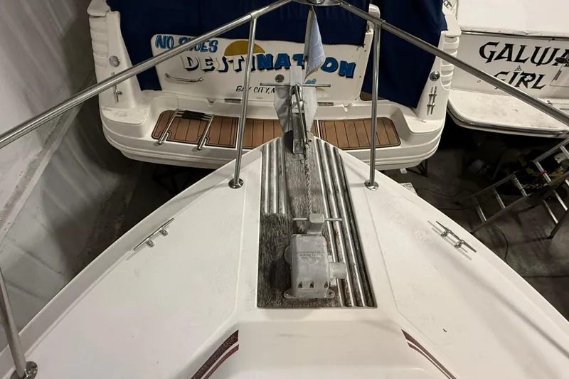 Slide: The Image of 1989 Sea Ray 340 Express Cruiser bow with anchor, docked near other boats. - 31