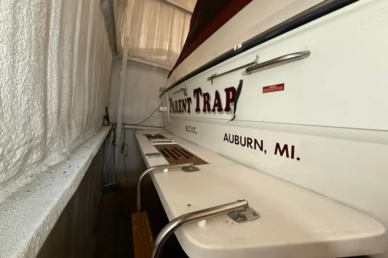 Slide: The Image of 1989 Sea Ray 340 Express Cruiser docked, featuring "Parent Trap" name, Auburn, MI location. - 33