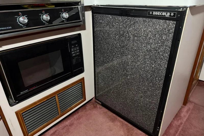 Slide: The Image of Galley kitchen in 1989 Sea Ray 340 Express Cruiser with microwave and Norcold fridge. - 7