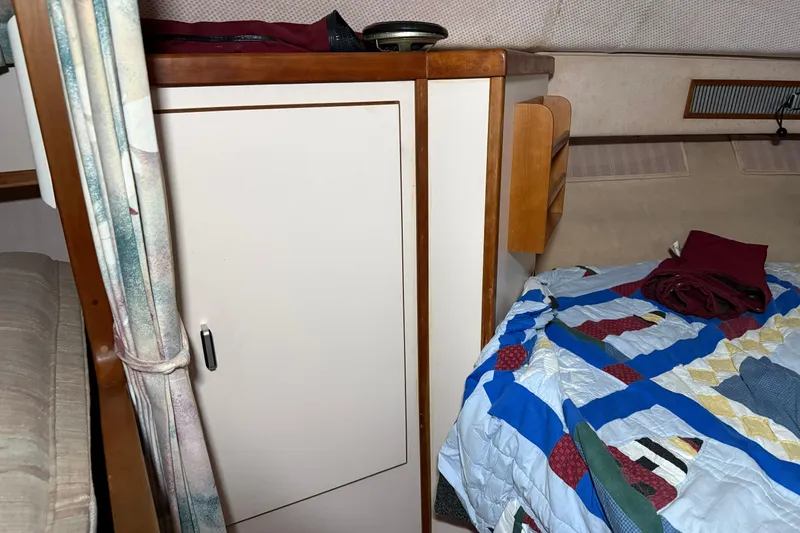 Slide: The Image of Interior cabin of 1989 Sea Ray 340 Express Cruiser with bed and storage. - 9