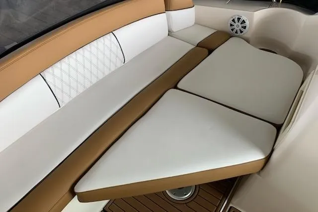 Slide: The Image of 2003 Rinker Fiesta Vee 342 boat interior with tan and white cushioned seating. - 11