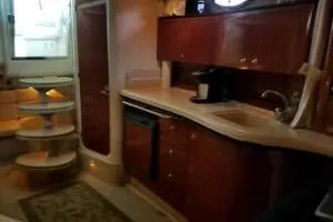 Slide: The Image of 2003 Rinker Fiesta Vee 342 yacht interior with kitchenette and stairs. - 12