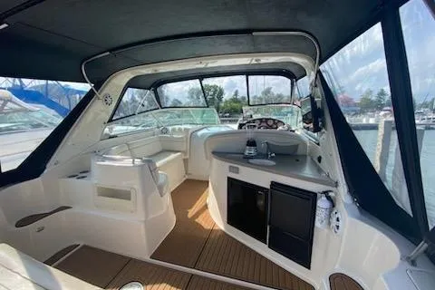 Slide: The Image of 2003 Rinker Fiesta Vee 342 boat interior with seating and helm, docked at marina. - 3