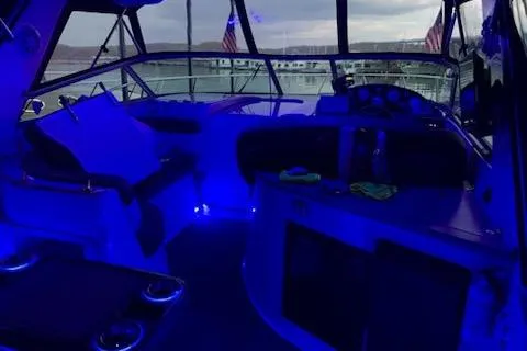 Slide: The Image of 2003 Rinker Fiesta Vee 342 boat interior with blue ambient lighting and American flags. - 6