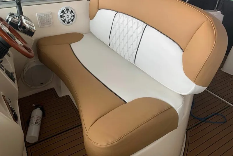 Slide: The Image of 2003 Rinker Fiesta Vee 342 boat interior with tan and white seating. - 7