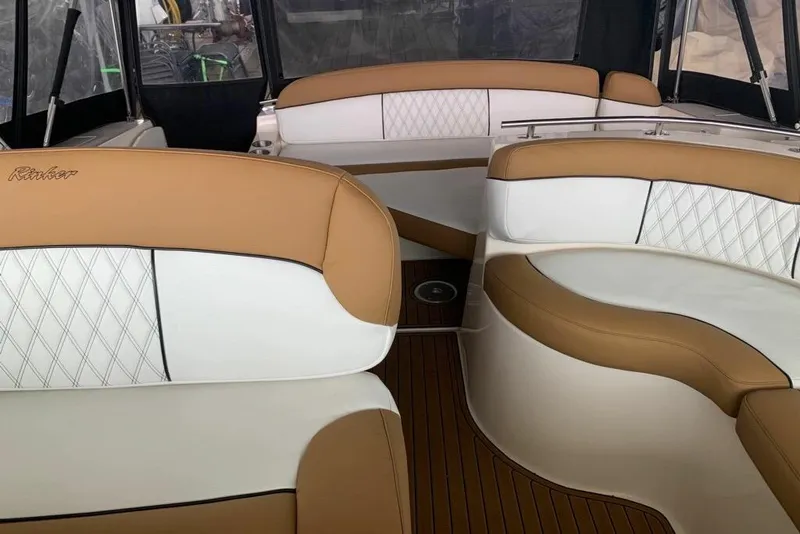 Slide: The Image of Interior of 2003 Rinker Fiesta Vee 342 boat with tan and white seating. - 8