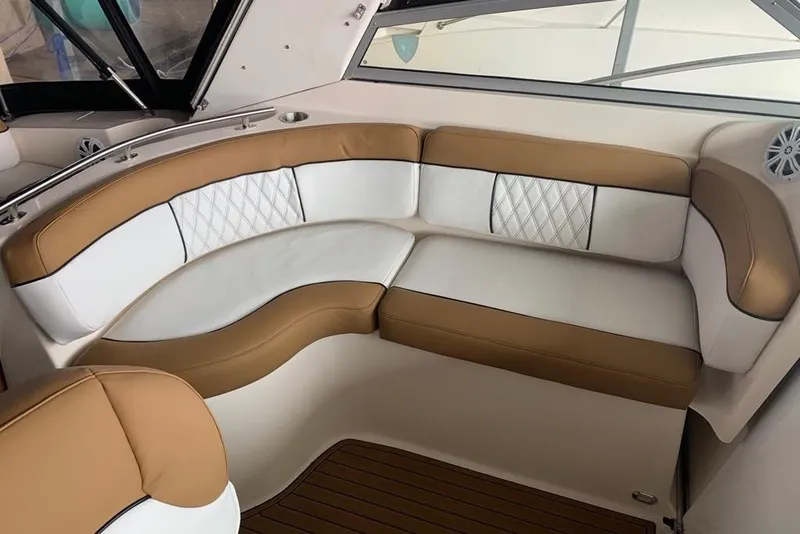 Slide: The Image of Luxurious seating area on a 2003 Rinker Fiesta Vee 342 boat, featuring tan and white upholstery. - 9