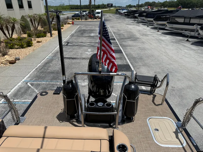 Slide: The Image of 2023 Barletta Lusso 25UE pontoon boat with American flag at dock. - 22