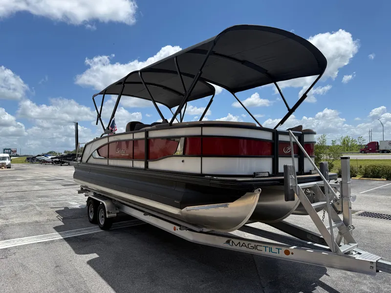 Slide: The Image of 2023 Barletta Lusso 25UE pontoon boat on trailer in sunny weather. - 4