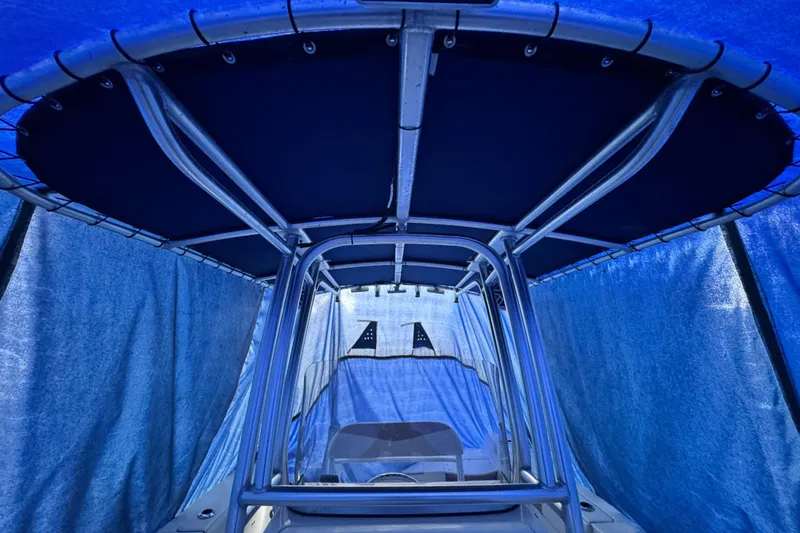 Slide: The Image of 2015 Robalo R200 Center Console boat under blue tarp cover. - 11