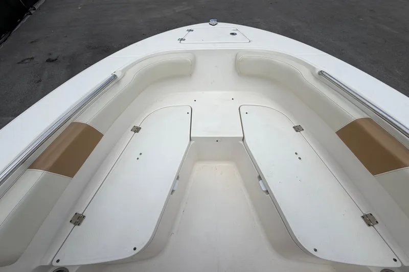 Slide: The Image of 2015 Robalo R200 Center Console boat interior with white seating and storage compartments. - 26
