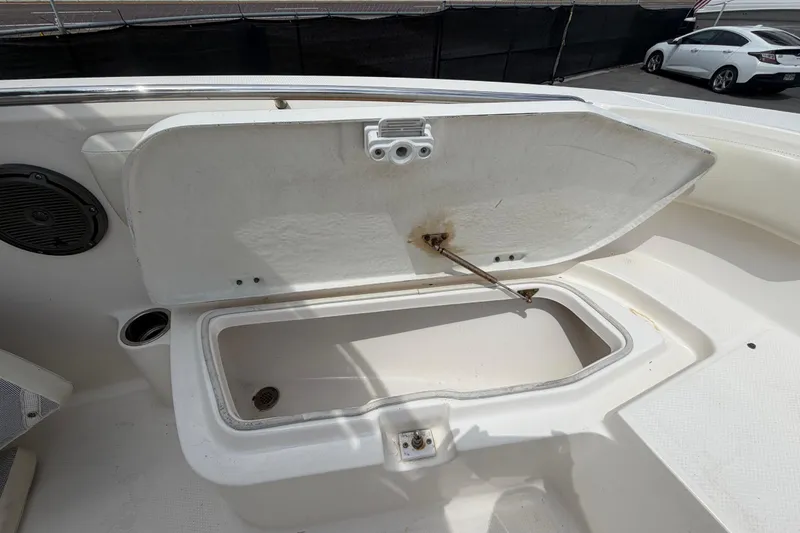 Slide: The Image of Open storage compartment on 2015 Robalo R200 Center Console boat. - 28