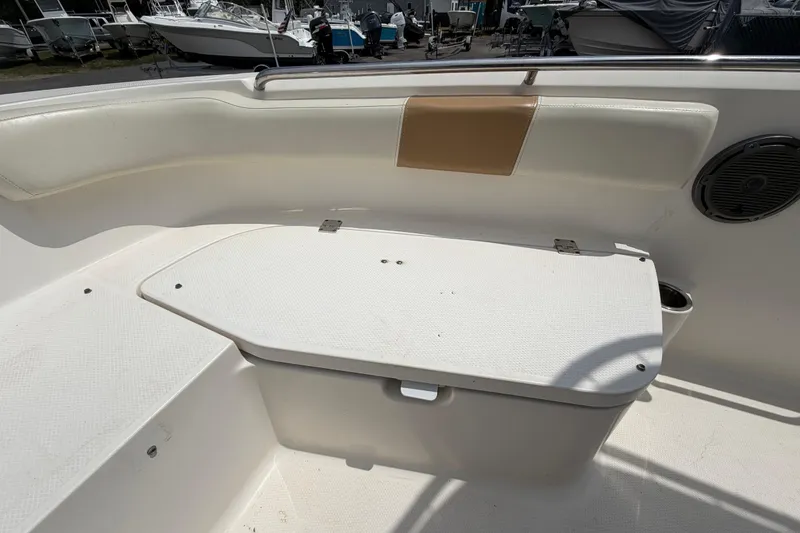 Slide: The Image of 2015 Robalo R200 Center Console boat interior with seating and storage compartment. - 31
