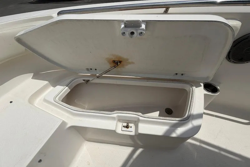 Slide: The Image of Open storage compartment on 2015 Robalo R200 Center Console boat. - 32