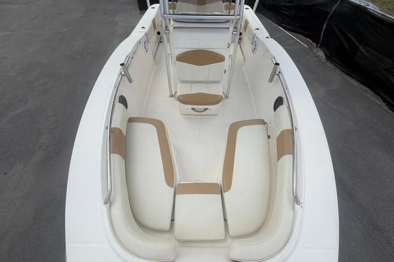 Slide: The Image of 2015 Robalo R200 Center Console boat interior with cushioned seating and stainless steel rails. - 33