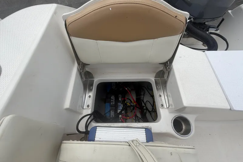 Slide: The Image of 2015 Robalo R200 Center Console boat seat storage with wiring and battery. - 47