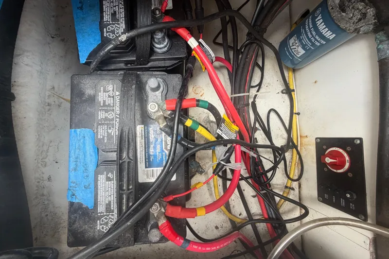 Slide: The Image of 2015 Robalo R200 Center Console boat battery compartment with wiring and switch. - 49