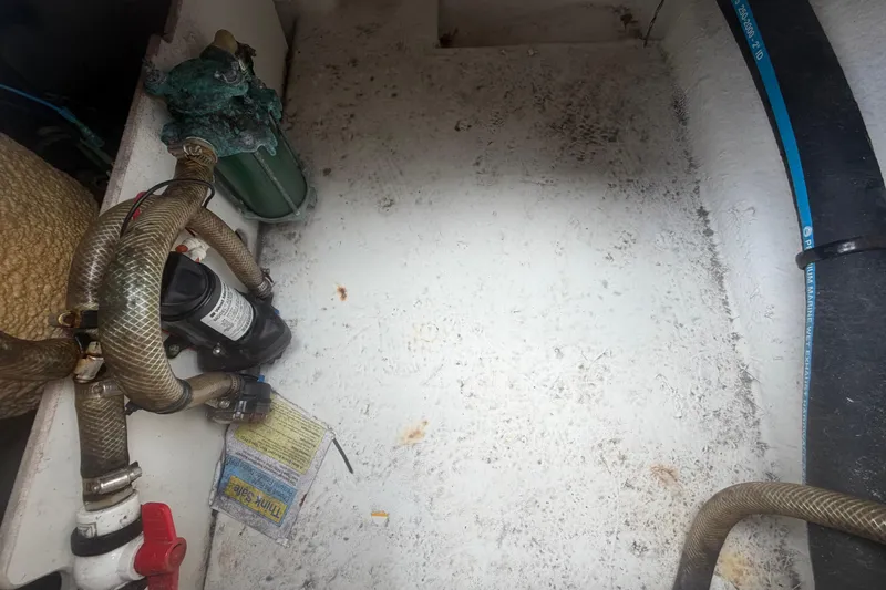 Slide: The Image of 2015 Robalo R200 Center Console boat interior with hoses and marine equipment. - 52