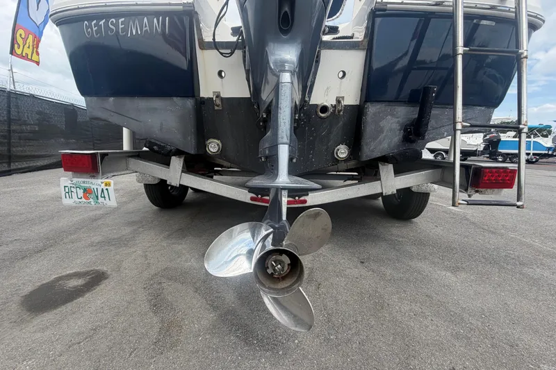 Slide: The Image of 2015 Robalo R200 Center Console boat covered on trailer under cloudy sky. - 58