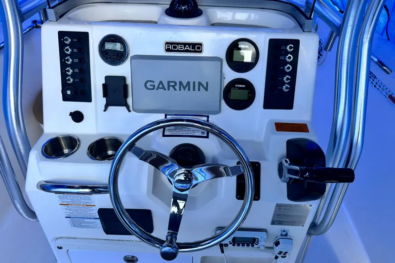 Slide: The Image of 2015 Robalo R200 Center Console dashboard with Garmin navigation system and steering wheel. - 6