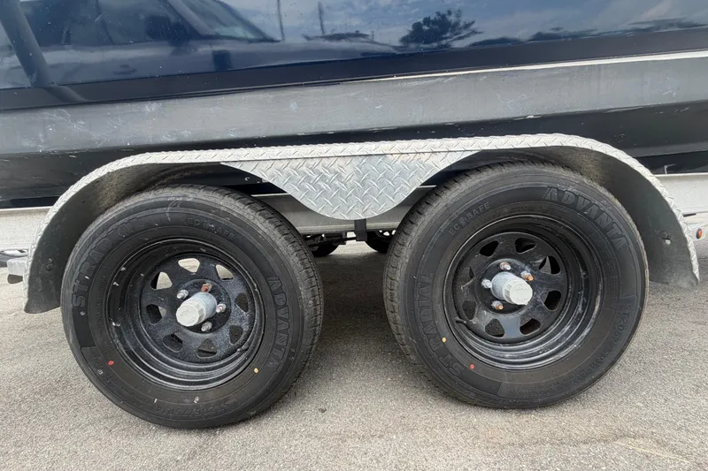 Slide: The Image of Trailer wheels of a 2015 Robalo R200 Center Console boat. - 61