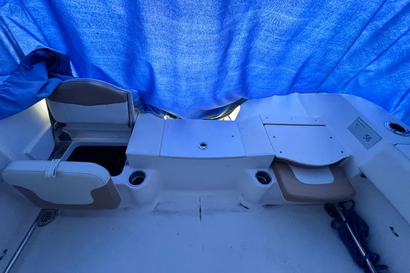 Slide: The Image of 2015 Robalo R200 Center Console boat interior with blue tarp cover. - 9