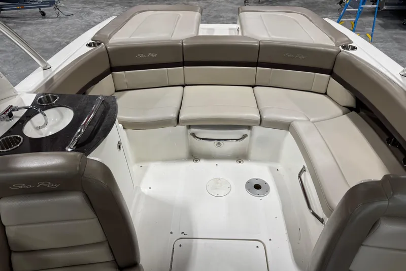 Slide: The Image of 2011 Sea Ray SLX 250 boat interior with beige seating and built-in sink. - 10