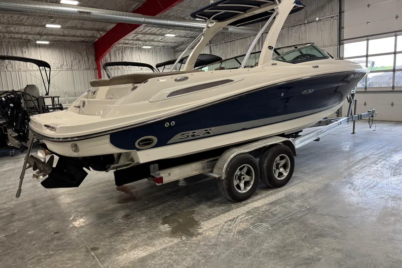 Slide: The Image of 2011 Sea Ray SLX 250 boat on trailer in indoor storage facility. - 3
