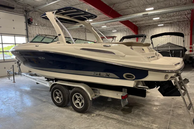 Slide: The Image of 2011 Sea Ray SLX 250 boat on trailer in indoor storage facility. - 4