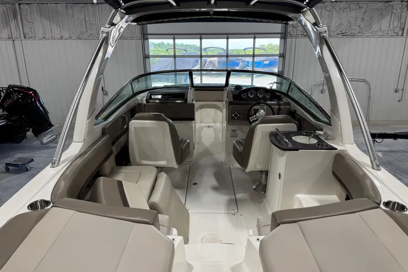 Slide: The Image of Interior view of a 2011 Sea Ray SLX 250 boat, showcasing seating and helm. - 6