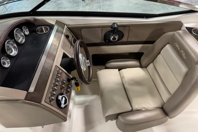 Slide: The Image of 2011 Sea Ray SLX 250 boat cockpit with steering wheel and control panel. - 9