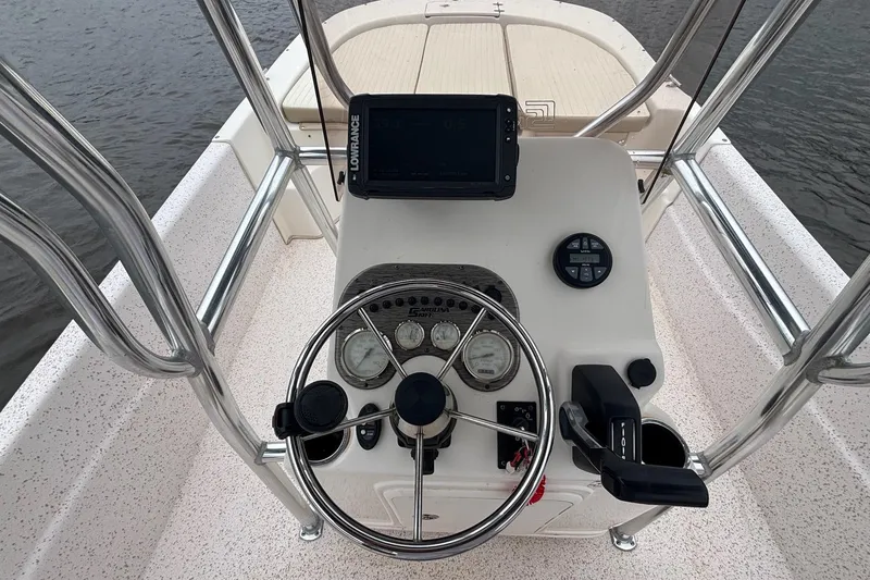Slide: The Image of 2019 Carolina Skiff 218 DLV boat console with steering wheel and navigation equipment. - 10