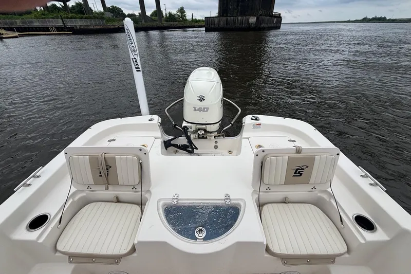 Slide: The Image of 2019 Carolina Skiff 218 DLV boat with Suzuki 140 outboard motor on a river. - 11