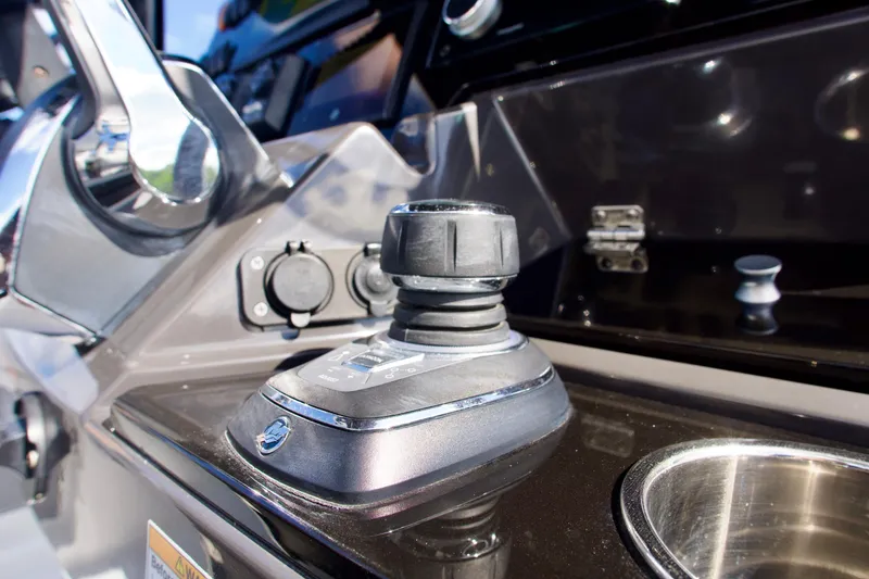 Slide: The Image of Close-up of 2023 Blackfin 302 CC boat control panel with joystick and chrome details. - 14