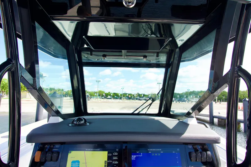 Slide: The Image of Interior view of 2023 Blackfin 302 CC boat cockpit with navigation screens. - 16