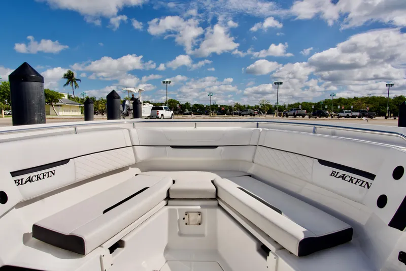 Slide: The Image of 2023 Blackfin 302 CC boat interior with seating, under a blue sky. - 19