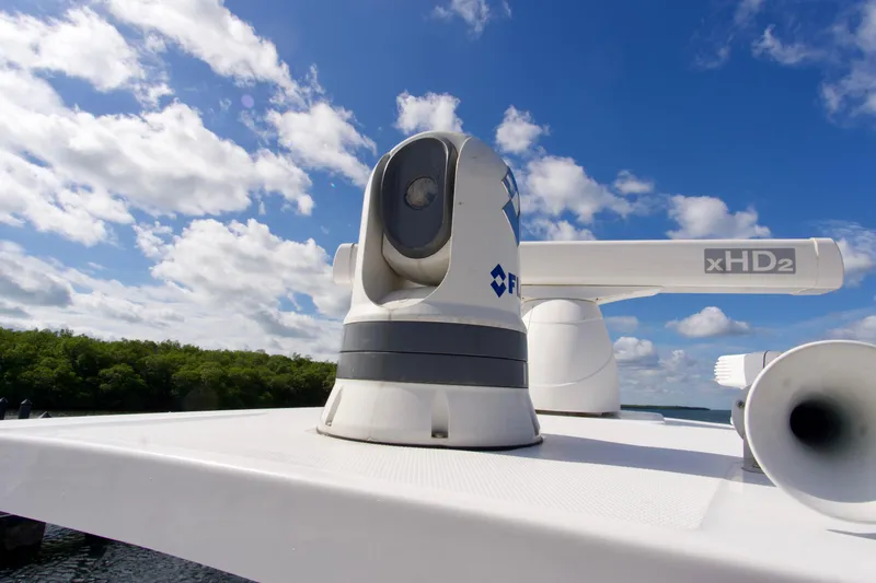 Slide: The Image of Radar equipment on 2023 Blackfin 302 CC boat under a blue sky. - 21
