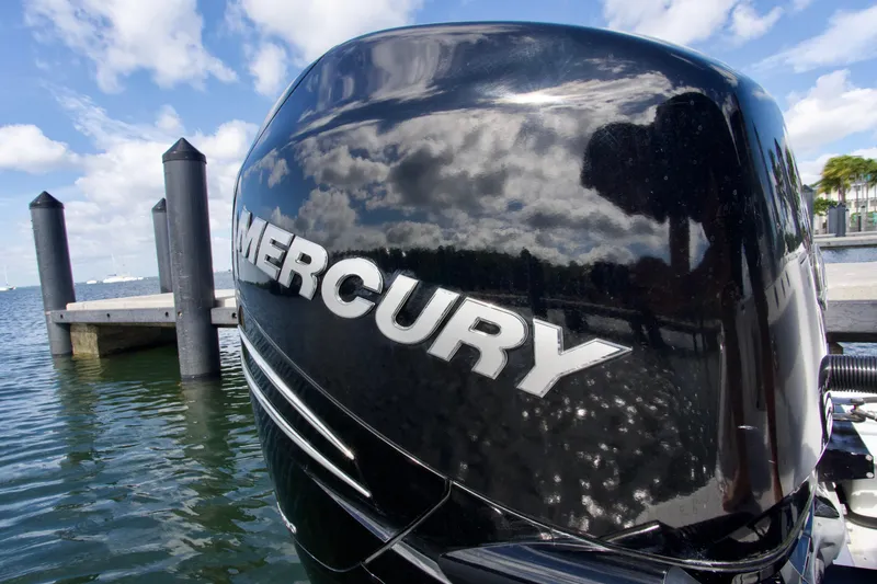 Slide: The Image of Mercury outboard engine on 2023 Blackfin 302 CC boat, docked by the water. - 26