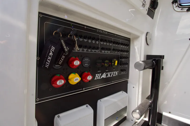 Slide: The Image of Control panel of 2023 Blackfin 302 CC boat with switches and key fobs. - 29