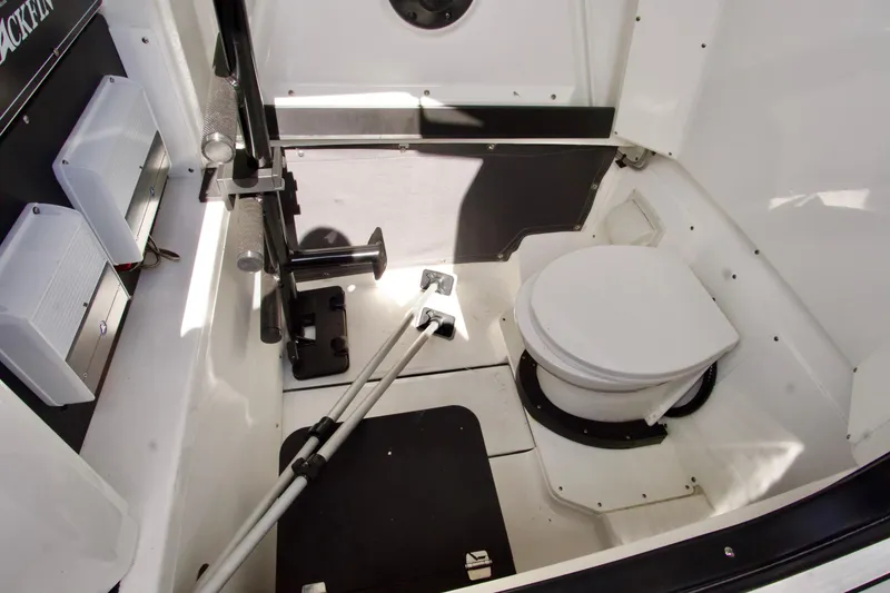 Slide: The Image of 2023 Blackfin 302 CC boat interior with toilet and storage area. - 30
